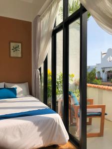 a bedroom with a bed and a large window at Terralia Villa in Lagi +54 photos