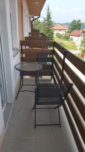 a table and chairs sitting on a balcony at Apartment Krstin Banja Vrujci in Gornja Toplica