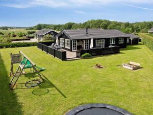 a large yard with a house and a playground at 5 star holiday home in Haderslev in Råde