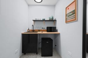 a kitchen with a sink and a counter at PR Rentals Ocean Park Beach Apartment 2 in San Juan