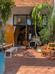 a patio with tables and chairs in front of a building at Terralia Villa in Lagi
