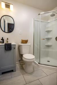 a bathroom with a toilet and a glass shower at Franklin in the Middle in Jonesboro