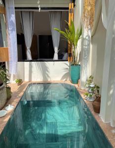 a swimming pool with a turquoise poolvisor at Terralia Villa in La Gi