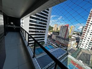 a balcony of a building with a swimming pool at Apartment 3 suites cop30 in Belém
