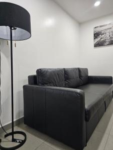 een zwarte leren bank in een kamer met een lamp bij NSI Alameda Park Humboldt Mexico City in Mexico-Stad +14 foto's