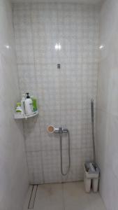 a bathroom with a shower and a toilet at Vila Raima SYARIAH in Gresik +12 photos