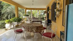 eine Terrasse mit einem Tisch und Stühlen auf einer Terrasse in der Unterkunft Nature and Comfort House with Pool 10 people 1h from SP in São Roque