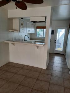 a kitchen with a sink and a counter top at Chalet Palm Condo in Rancho Mirage