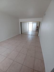 a large empty room with a person standing in the doorway at Chalet Palm Condo in Rancho Mirage