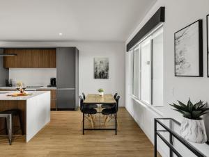 a kitchen and dining room with a table and chairs at Horizon - 2 Units - Jacuzzi - Private Balconies in Scottsdale