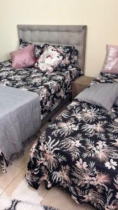 two beds sitting next to each other in a room at Nosso Sonho Praia Seca in Araruama