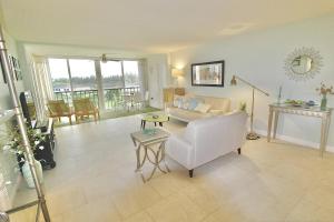 a living room with a white couch and a table at Catamaran Condo in Fort Pierce +24 photos