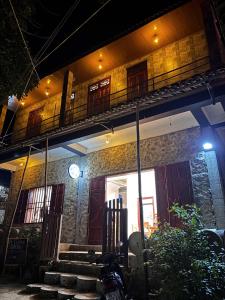a building with a balcony and stairs in front of it at A Tứng House Bản Giốc in Trùng Khánh +4 photos
