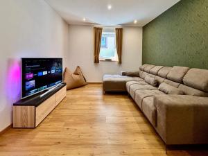 a living room with a couch and a flat screen tv at Apartment in Herbolzheim in Herbolzheim