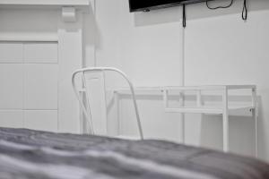 a white room with a bed and a white chair at Pittsburgh Shadyside 3C Bright and Stylish Private Bedroom with Shared Bathroom in Pittsburgh