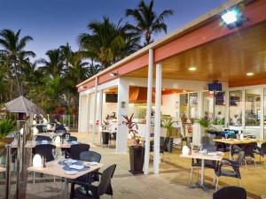 a restaurant with tables and chairs in front of a building at Tangalooma Sands in Tangalooma