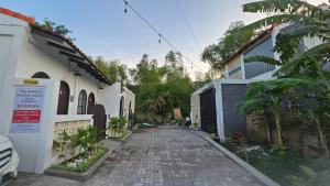 a cobblestone street in front of a house at Cute Room at Pondok Raima SYARIAH in Gresik