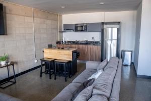 a living room with a couch and a kitchen at LOFT Apartment Downtown Area in Tijuana