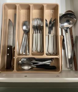 a drawer filled with utensils sitting on a counter at ApComplete in the center in Caxias do Sul