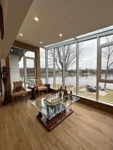a living room with a view of a river at Maison prestige sur la rive in Laval