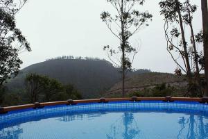a swimming pool with a mountain in the background at Apartamentos Playa La Franca in La Franca