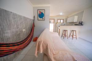 a room with a hammock in the corner of a kitchen at Casa Queiroz in Maracaipe +26 photos