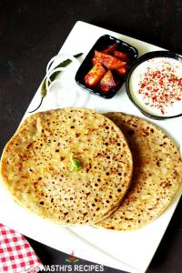 two pita breads on a plate with sauce and other food at Hotel Star City Delhi - Near IGI Airport & Aerocity in New Delhi