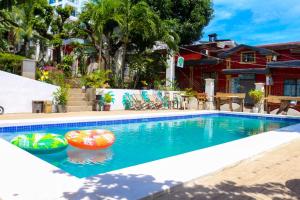 a swimming pool with a beach ball in a house at Green Gecko Pool Hostel and 3 Day Expedtion in Coron