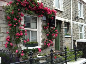 a building with flowers on the side of it at Mair's in Bridgend