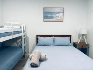 a bedroom with a bed and a bunk bed at Anchored at Eba in Eba Island