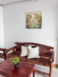a living room with a wooden bench and a table at Ace Travellers Inn- Palawan in Puerto Princesa City