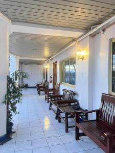 a row of wooden benches in a building at Ace Travellers Inn- Palawan in Puerto Princesa City