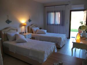 A bed or beds in a room at Melograno Apartments and Studios