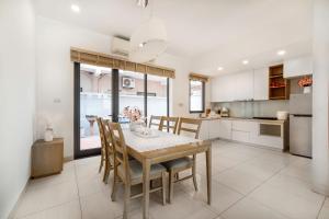 a kitchen and dining room with a table and chairs at ICON40 Ha Long Bai Chay in Ha Long