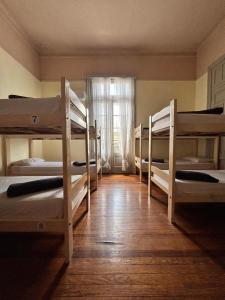 a room with four bunk beds and a window at Mitre778 in Rosario +5 photos