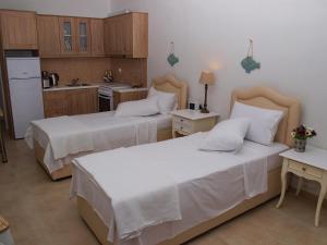 A bed or beds in a room at Melograno Apartments and Studios