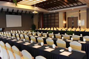 a conference room with tables and chairs and a screen at YONG JING VILLA in Suzhou
