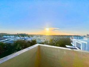 a view of the sunset from the balcony of a building at Soleil Couchant Apt 8 in Flic-en-Flac