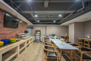a dining room with a long table and chairs at James Joyce Coffetel Shijiazhuang the Mixc Jinyuan Tower Airport Bus in Shijiazhuang