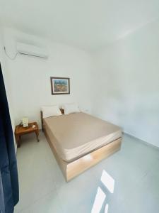 a small bedroom with a bed and a table at Accacia Residence in Post of Flacq