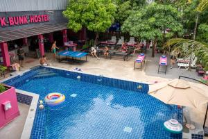 an overhead view of a swimming pool with people playing volleyball at K-Bunk AoNang Center in Ao Nang Beach