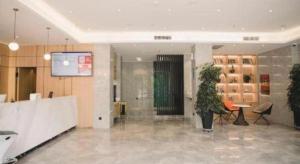 a lobby with a plant and a screen in a building at GreenTree Inn Express Datong High-Speed Railway Station Old City Wall in Datong