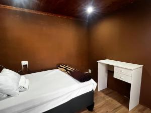 a bedroom with a bed and a white desk at VB Accomodation (STATION HOME) in Cape Town