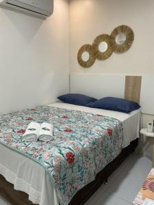 Una cama o camas en una habitación de Pousada suítes Pitanga