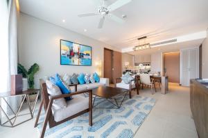 a living room with a couch and a table at Luxury Infinity Sky Pool Suite Angsana Laguna Lakeside in Phuket Town