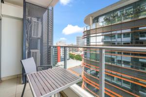 a balcony with a table and a view of a city at Darwin City Centre Apt 2 Bed, 2 Bath in Darwin