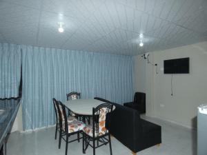 a dining room with a table and chairs and a couch at Huayo Wasi II in Huaraz