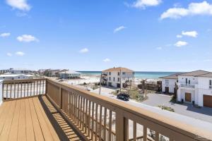 a balcony with a view of the beach and the ocean at Sea'scape - Heated Pool, Beach Gear, Pet Friendly, Beach Views in Pensacola Beach