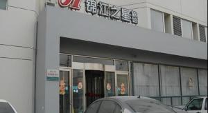a building with a car parked in front of it at Jinjiang Inn Tianjin Zhongshan Road in Tianjin