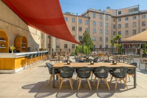 an outdoor patio with tables and chairs and buildings at Armenia Marriott Hotel Yerevan in Yerevan